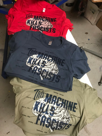 This machine kills fascist Women's T-shirt. Gunmetal Blue, OD Green, Flag Red Printed with water based ink